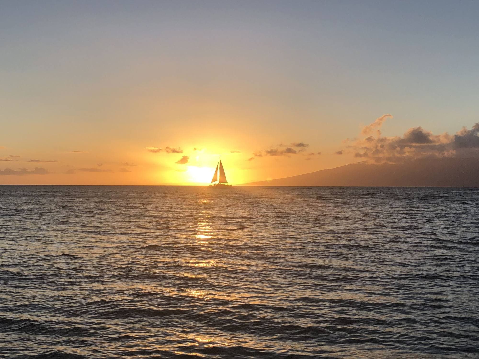 Catamaran silhouetted against a West Maui sunset